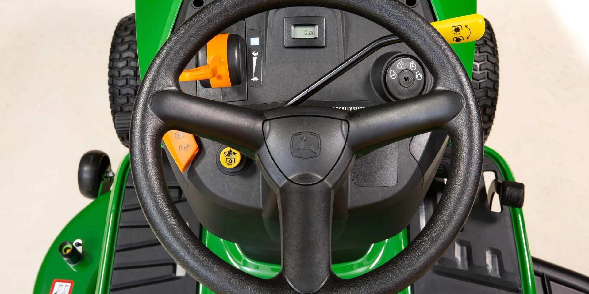 John Deere tractor on open farmland at golden hour